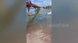 Stranded elderly couple rescued after driving their truck into gushing spillway in Thailand