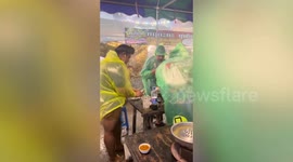 Hungry customers carry on eating as storm whips through barbecue restaurant in Thailand
