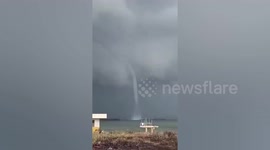 Large waterspout forms terrifyingly close to beach in the Philippines
