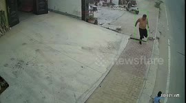 Neighbour runs to stop 1-year-old crawling onto busy road in central China