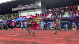 Competitive officers race to cross finish line during annual police sports festival in Thailand