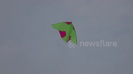Kite enthusiasts fly their colourful creations alongside palace in Bangkok, Thailand