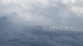 Thunderstorm in Italy with lightning behind the clouds and in the sea