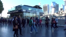 The queue of Queens mourners is moving past HMS Belfast warship on the River Thames