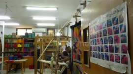 Deaf Palestinians work on a traditional loom to make the Majdalawi's fabric on International Week of Deaf People 2022