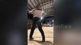 Enthusiastic sports referee cartwheels and dances across floor during basketball game