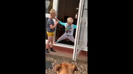 Toddler being stubborn not letting his older brother in the door, his legs were so stretched out it made us chuckle