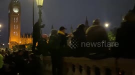 Mourners sit on walls near Big Ben before sunrise for Queen’s funeral