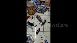 Shards of glass and bottles on shop floor after earthquake hit Mexico