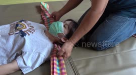 Extreme Thai massage uses loin cloth to pull and stretch muscles