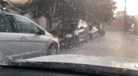 Hail and rain in the street filmed from the inside of the car