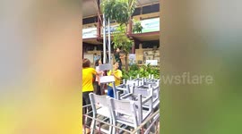 Resourceful teachers use rope to slide chairs down from third floor classrooms in Thailand