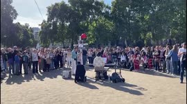Teenager pays respects to the royal family outside Westminster Abbey with an emotional rendition of God Save the King