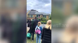 Elderly woman warms the hearts of funeralgoers in Windsor by waving to the crowds from her window