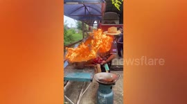 Cook dodges burst of flame surging towards his face from wok