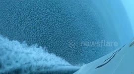 Satisfying footage shows ship cruising through sea topped with icy balls