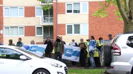 Anti-Putin protesters pause for a minute's silence for the Queen in Sydney, Australia
