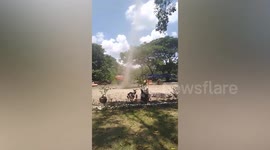 Snake-like dust devil tornado greets mesmerised tourists visiting church ruins in the Philippines