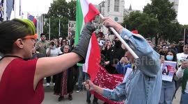 Iranian woman burns flag next to Churchill Statue in protest for Mahsa Amini