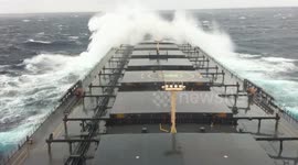 Large capsized vessel battles to stay up as massive storm hits the Pacific Ocean
