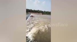 Thai villager trapped on a river weir during ill-advised shortcut, is rescued