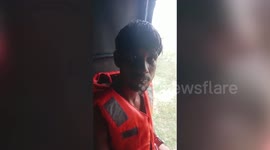 Youths rescued after getting trapped in the middle of a flooded river in central India