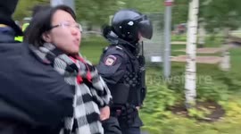 Batons drawn, Russian riot police drag away people standing in a Moscow park amid anti-war protests