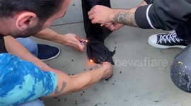 Mahsa Amini protesters burn a hijab in Trafalgar Square