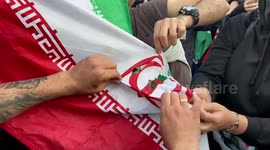Mahsa Amini protesters burn an Islamic Republic of Iran flag in Trafalgar Square