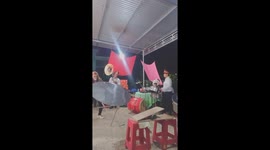 Woman standing on a plank on a round pipe and using her mouth to raise the  table