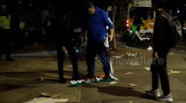 Pro-Iranian regime supporter tears pre-revolution flag