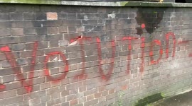 Protesters spray paint 'Iran revolution' outside Iranian Embassy in London during Mahsa Amini protests
