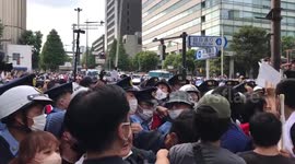 Police attempt to hold back protesters near venue of Shinzo Abe's state funeral