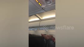 Plane passengers terrified as mystery dark liquid drips from overhead compartment during flight