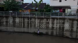 Thai villager rescues hapless puppy after it fell into 15ft deep canal