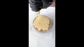Chef captivatingly frosts cookie with smiley wearing a daisy crown