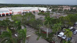 Downed trees and damages seen by Hurricane Ian's winds  in south Florida parking lot