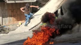 Palestinian youth throw rocks at Israeli troops in Hebron after deadly military raid on Jenin refugee camp