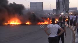 Youths burn tires during a protest against the killing of 4 Palestinians by Israeli forces near Hawara military checkpoint, in the West Bank city of Nablus