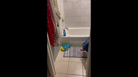 Woman finds her daughter hiding behind shower curtain while sitting on toilet seat