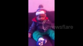 Baby boy falls asleep on a couch