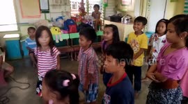 shy boy doing the 'coin relay'game at school's Christmas party