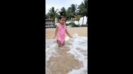 Toddler girl confused on what to do on her first seashore experience (funny)