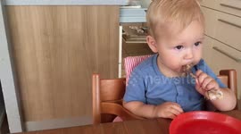 Baby tries to eat chicken leg bone