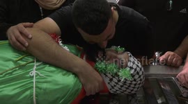 Mourners attend the funeral of Palestinian Mohammed al-Shaham, 21, at the Qalandia refugee camp in the West Bank
