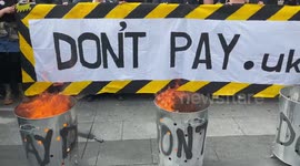 London protesters burn energy bills during 'Enough is Enough' rally