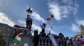 A woman cuts off her hair during a Mahsa Amini protest in Trafalgar Square