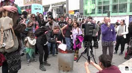 Don't pay UK protesters burn their utility bills at the Clock Tower in Brighton.