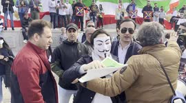 A woman is lead away after trying to disrupt a protest against the Iranian goverment and protest against the death of  Mahsa Amini