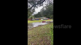 US: Kids Enjoy Canoeing Down Flooded Street In South Carolina After Hurricane Ian Strikes